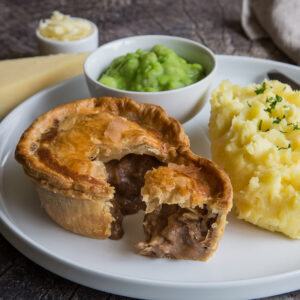 Steak pie with mash and peas