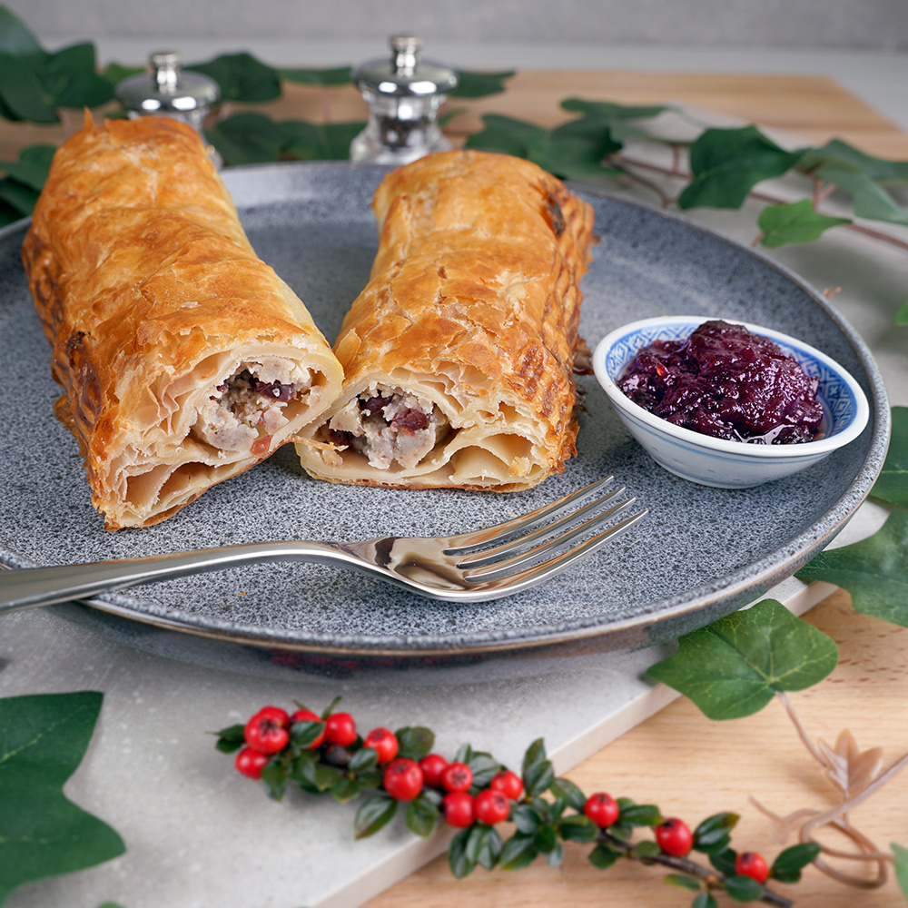 chicken_stuffing_cranberry_foot_long_sausage_roll_cut Foot long pork, chicken, stuffing and cranberry sausage roll, cut in half