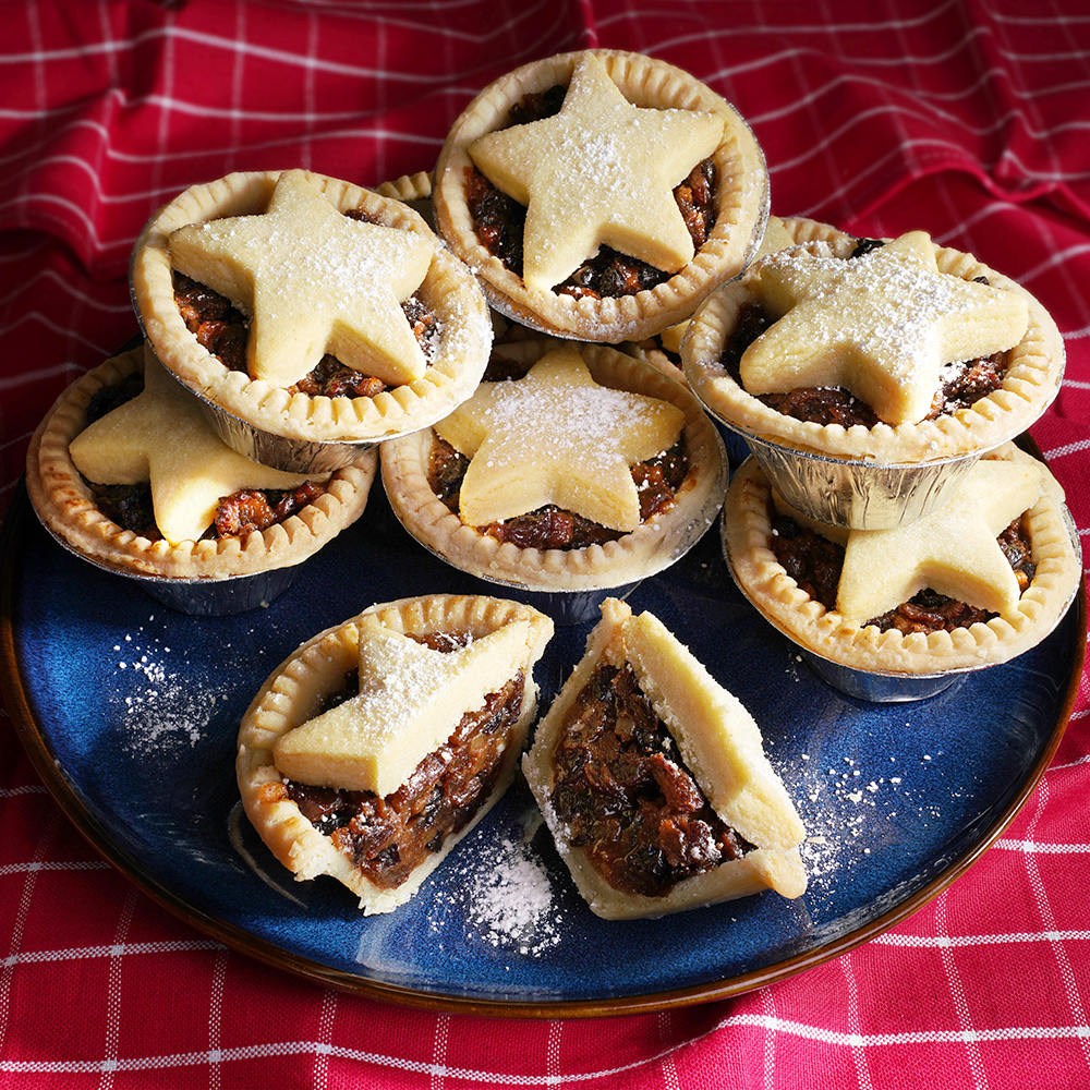 8 boozy mince pies stacked on a plate