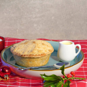 Plumb and blackberry crumble with a small jug of cream